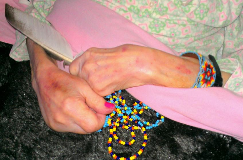 The Feather My mom's sweet hands holding her eagle feather and beads giving to her by Chief Medicinehawk and Princess Moonwind when they christened her an Indian Princess - Princess Harvest Moon.